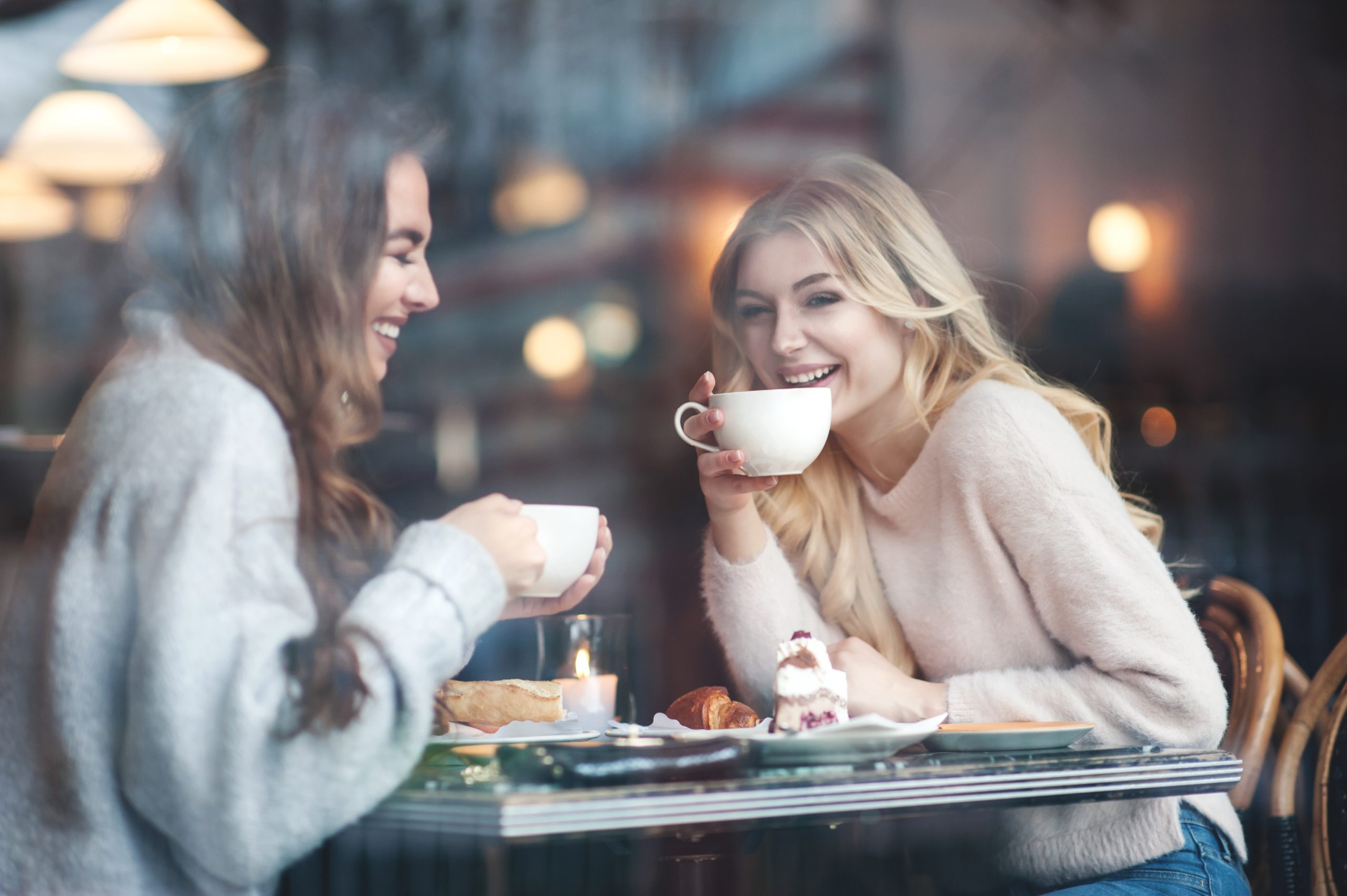 Two women drinking coffee.