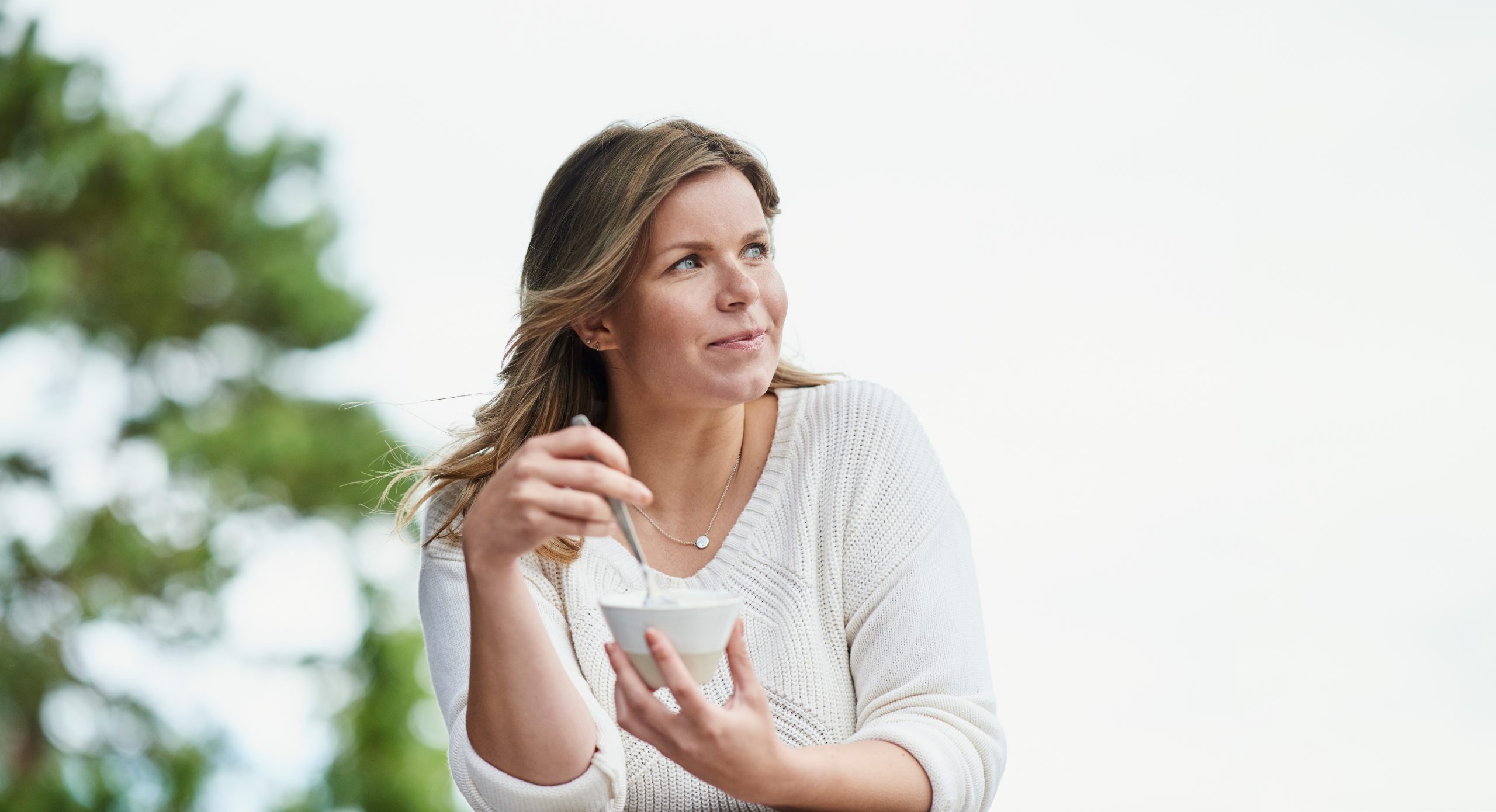 Woman eating yogurt.