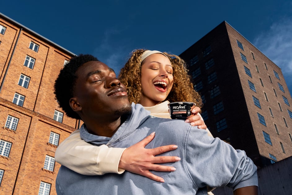 Man and woman hugging each other enjoying PROFeel protein pudding