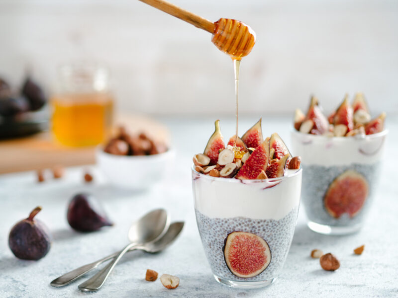 Chiapudding with yoghurt, figs and nuts in a glass. 